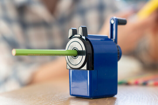 Close-up shot of a special creative sharpener standing on the table with pencil inside	