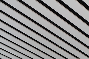 Obraz premium Lights and ventilation system in long line on ceiling of the industrial building. Exhibition Hall. Ceiling factory construction.