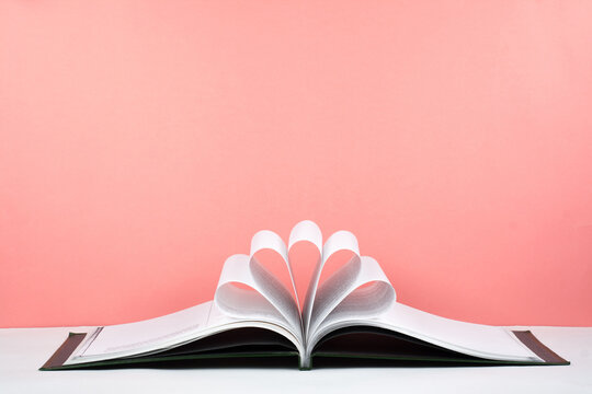 Old open hardback book, page decorate into a flower shape for love in Valentine's. love with open book heart.