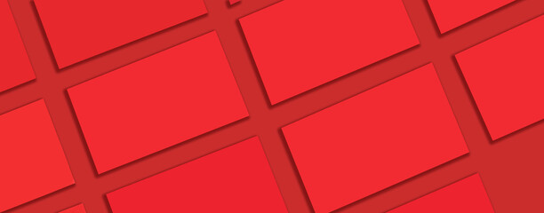 Obraz premium Mockup of horizontal red business cards stacks arranged in rows at red textured paper background. Banner.