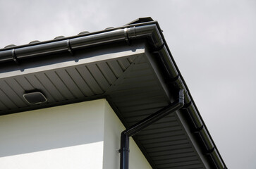 Plastic gutter system on a house with security system