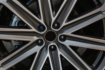 A close up of a car wheel with a sleek black and silver alloy rim, showcasing modern automotive...