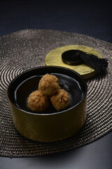 baked luxury tart in Japanese hojicha crisp with cranberry pineapple jam paste inside with chicken floss and plate gold fork knife on dark table vegan pastry dessert halal gluten free cafe food menu