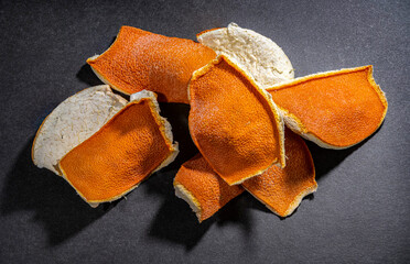 Dried orange peels on a dark background