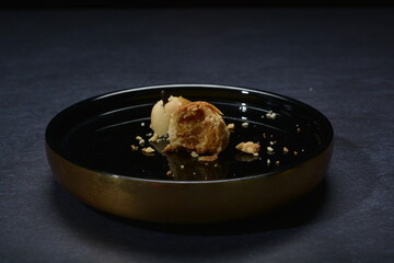 baked luxury tart in peranakan nyonya crisp with cranberry pineapple jam paste inside with clove stick and plate gold fork knife on dark table vegan pastry dessert halal gluten free cafe food menu