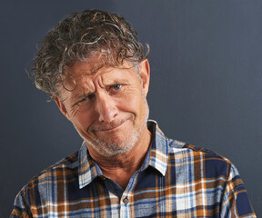 Obraz premium Mature, man and portrait with doubt in studio on dark background with confused questions. Senior, face and unsure person with faq information or guy on mockup space with plaid pattern in fashion
