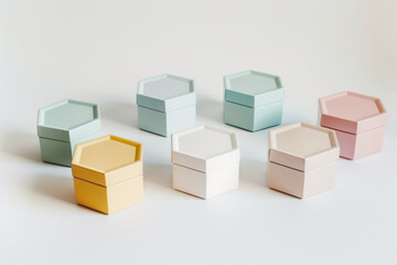 Fototapeta premium Elegant arrangement of open and closed pastel-colored gift boxes on a clean white backdrop