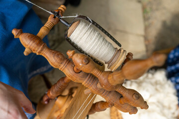 Traditional hand processing of wool by women. Traditional manual production process.