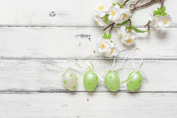 Easter eggs in a row and decorative cherry branch on a white wooden background. Top view, flat lay, . - 759752447