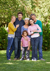 Fototapeta premium Family, portrait and hug in outdoor park, love and bonding together or happy in backyard. Generations, smile and peace or embrace for support in garden or care, vacation and summer holiday in France