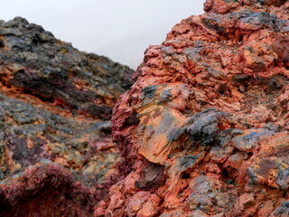 Red colored volcanic rock on the summit of Dolomieu crater, Piton de la Fournaise, Reunion island