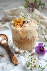 Obraz na płótnie Canvas featuring Ice Latte with Peanut Butter and edible Flowers on the light colour marble countertop