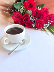 Bouquet of red roses and a cup of coffee. love confession. Romantic greeting card.