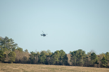 British army AgustaWestland AW159 Wildcat AH1 helicopter in low level flight over countryside