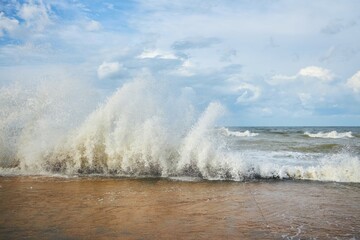 A storm and splashes of waves on the shore of the sea or ocean. The impact of water on the shore