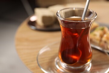 Traditional Turkish tea in glass on table, closeup. Space for text