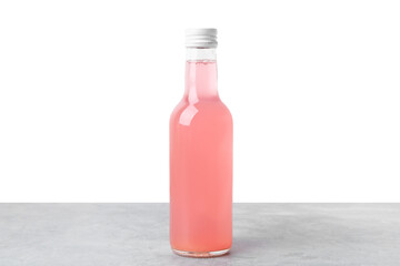Delicious kombucha in glass bottle on grey table against white background
