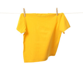 One yellow t-shirt drying on washing line isolated on white