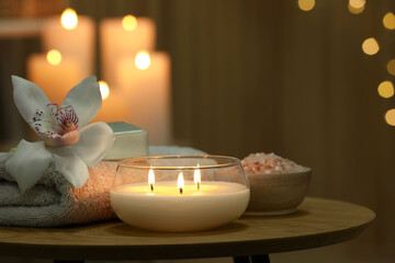 Composition with different spa products and orchid flower on wooden table