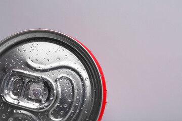 Energy drink in wet can on light grey background, top view. Space for text