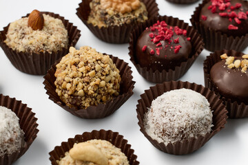 Set of round chocolate candies with nuts on a white background