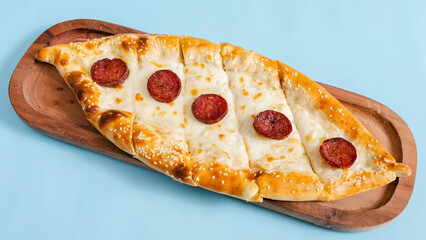 Sausage and cheese pide on tray