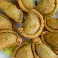 Gujia or Gujiya is a traditional Indian sweet or dessert made during Holi ,Diwali Festival.Resembles Spanish Empanada is deep fried or baked.Made from floor,milk solids,sugar,raisins,semolina.Closeup.