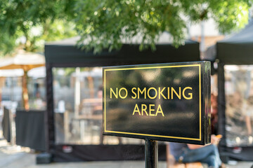 No smoking area sign outside in the street