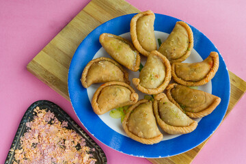 Gujia or Gujiya is a traditional Indian sweet or dessert made during Holi ,Diwali Festival.Resembles Spanish Empanada is deep fried or baked.Made from floor,milk solids,sugar,raisins,semolina.Closeup.