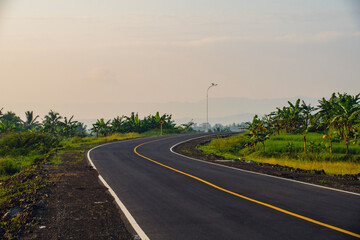Portrait of a highway in the morning in a small town with sunlight 