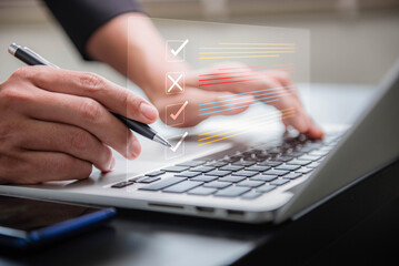 Digital smart checklist and business management concept. Businessman uses laptop to mark paperless...