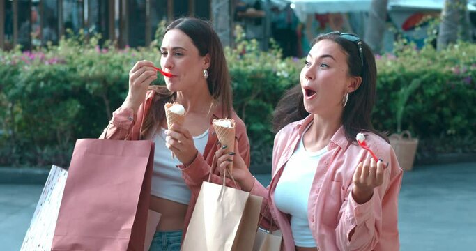 Two women on street enjoy ice cream express vibrant feelings Ice cream symbolizes sweet life happiness. Ice cream taste of joyful camaraderie bliss Sharing happiness savoring delightful tastes.