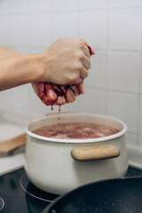 Cooking borsch on an induction stove in the kitchen