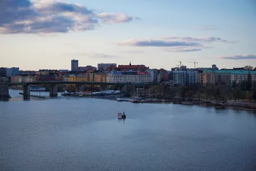 Foto op Canvas a river with a city in the background © niklas storm