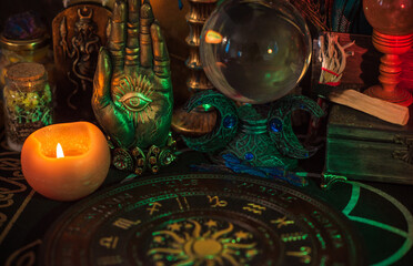 Table with candles and esoteric stuff. Herbs and wax around. Rite concept 