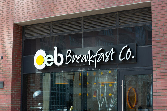 exterior building facade windows and sign of OEB Breakfast Co, a breakfast restaurant, located at 125 East Liberty Street in Toronto, Canada