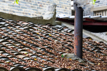 Close-up of chimney on tiled roof of rural house in China