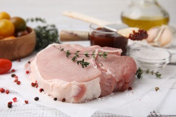 Raw meat, thyme and spices on table, closeup