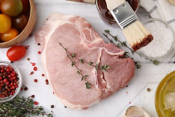 Flat lay composition with raw meat, thyme and marinade on white table