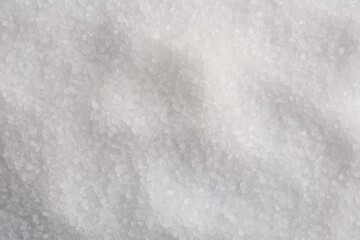 White natural salt as background, top view