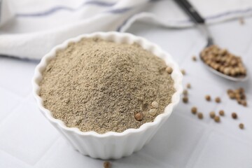Ground pepper on white tiled table, closeup