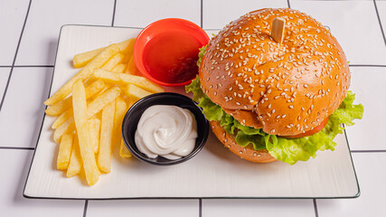 Burger, French fries, ketchup and mayonnaise