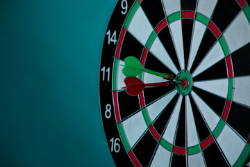Dartboard on a blue background with arrows hitting the center target