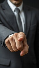 Fototapeta premium Confident businessman black suit pointing directly at camera