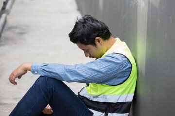 Asian male worker tired and thirst of water at construction site. Construction builder worker feel...