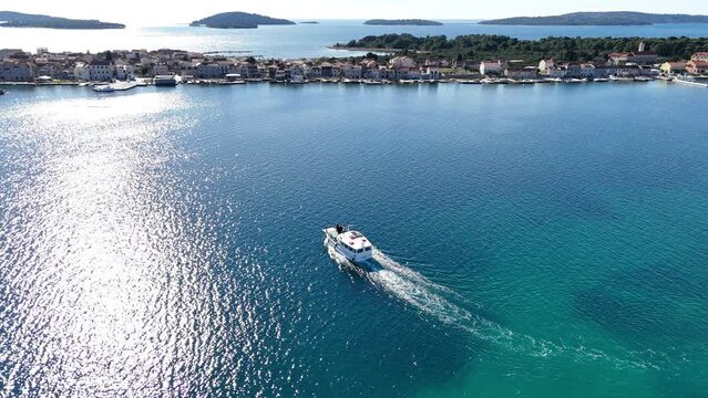 The ferry sails towards the island - Island of Krapanj - 4k aerial shot, not edited