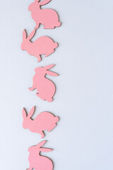 set of pink rabbits made of wood on paper