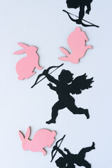 silhouette of cupid and pink bunnies