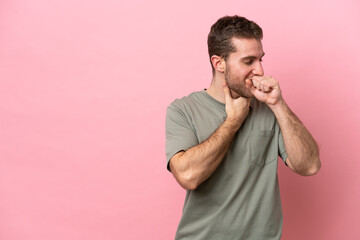 Young caucasian man isolated on pink background coughing a lot