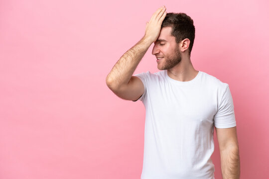 Young caucasian man isolated on pink background has realized something and intending the solution